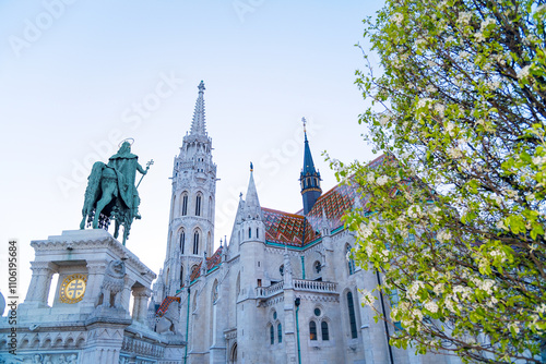 Matthias Church and Stephen I of Hungary monument view with flowering tree photo