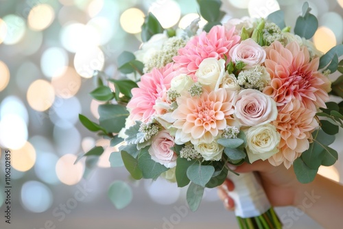 Beautiful floral bouquet featuring pink and cream roses with greenery for spe...