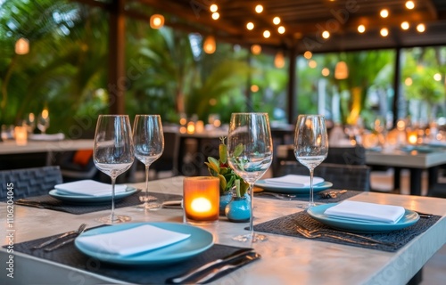 Elegant outdoor dining setup in tropical garden with ambient lighting in evening