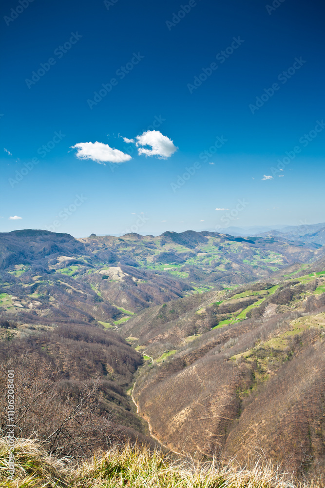 Fototapeta premium Aerial View of Mountain Landscape with Blue Sky and Clouds 