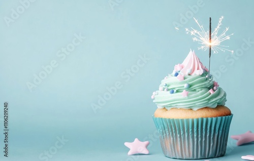 Celebrating a birthday with a sparkling cupcake topped with frosting and a ca...