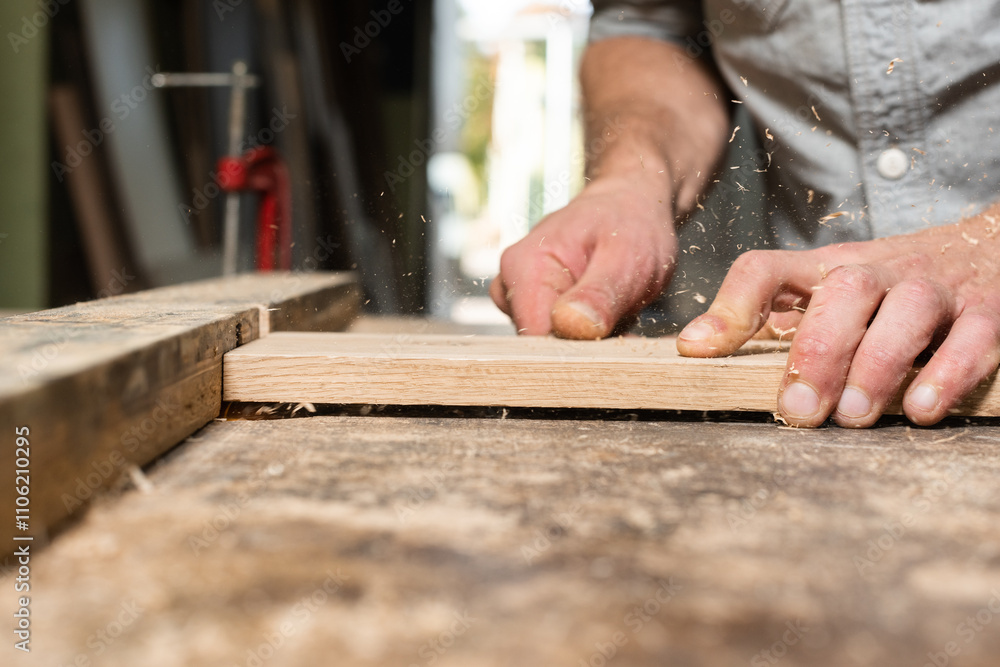 The carpenter manually mills the part The carpenter manually mills the part