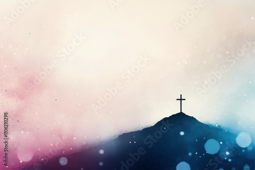 Cross stands on a mountain peak shrouded in mist during early morning