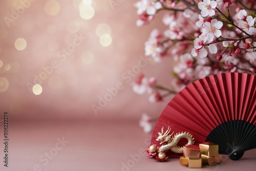 Cherry blossom decoration with a red fan and gold gifts for a cultural celebr...