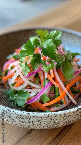 Colorful vegetable salad with carrots, onions, and cilantro served in a decor...