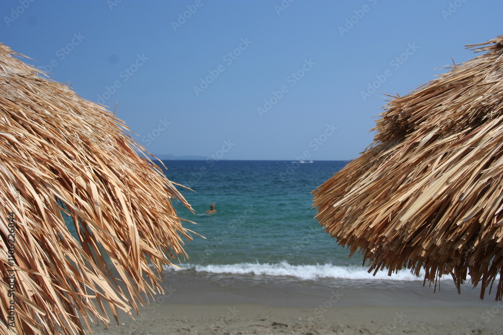 Straw umbrella on the beach Straw umbrella on the beach