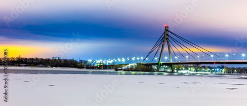Night view of the Pivnichnyi Bridge ex Moskovsky bridge on the Dnieper river in Kiev, Ukraine, at evening during the blue hour. high resolution panorama