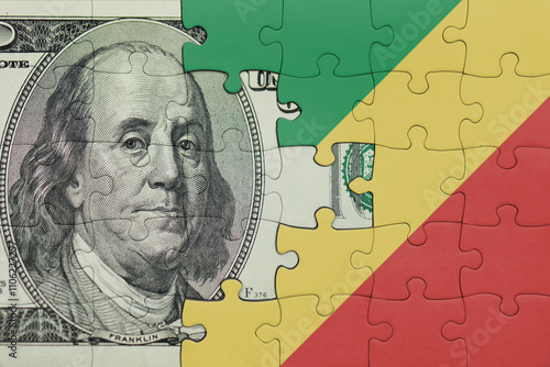 puzzle with the national flag of republic of the congo and the usa dollar money .finance concept