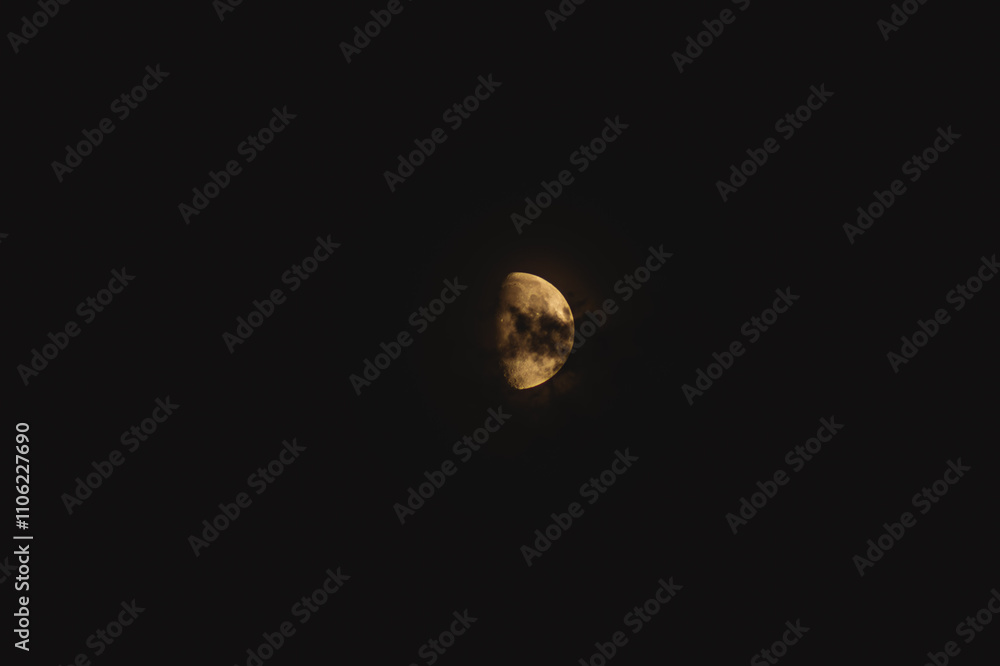 a large crescent moon illuminated against a stark, dark night sky. The surface of the moon is visible with various textures and craters, creating a detailed appearance. a large crescent moon illuminated against a stark, dark night sky. The surface of the moon is visible with various textures and craters, creating a detailed appearance.