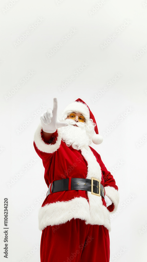 Fototapeta premium Santa claus in red suit pointing forward for christmas promotion and festive design
