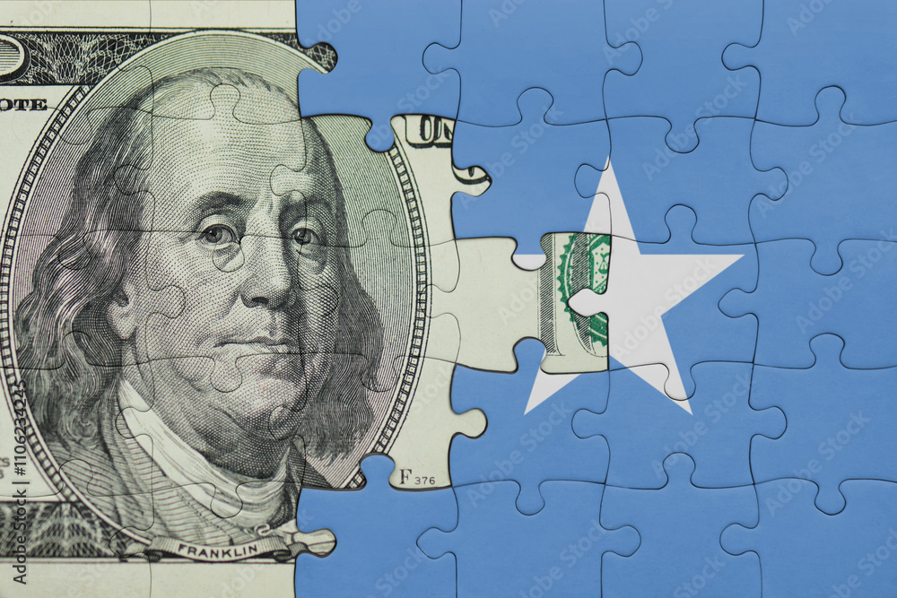 puzzle with the national flag of somalia and the usa dollar money .finance concept puzzle with the national flag of somalia and the usa dollar money .finance concept
