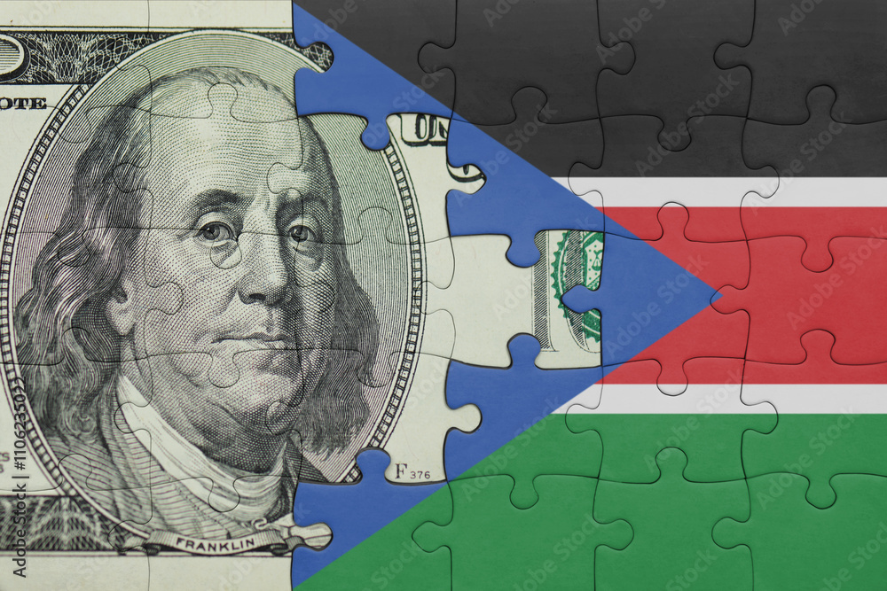 puzzle with the national flag of south sudan and the usa dollar money .finance concept puzzle with the national flag of south sudan and the usa dollar money .finance concept