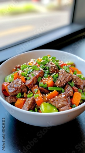 Savory beef stir fry served in a black bowl garnished with vegetables and sauce