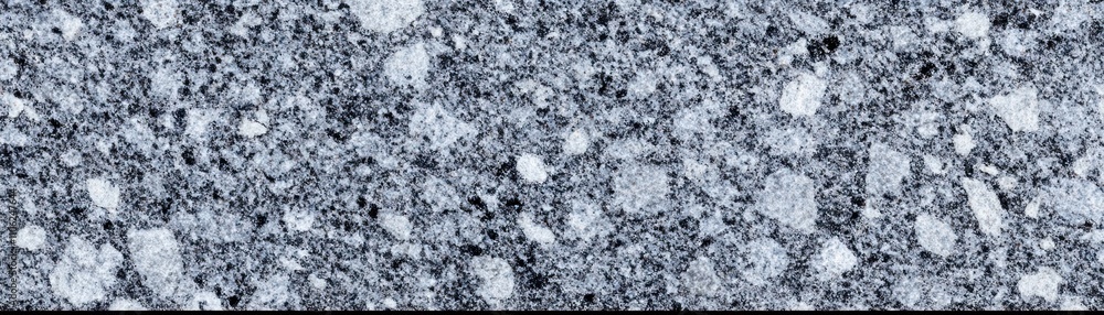 A textured surface with various shapes and shades, resembling a mineral or aggregate material. A textured surface with various shapes and shades, resembling a mineral or aggregate material.