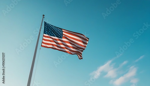 Proud flag flying in the wind, the symbol of America in beautiful blue sky. photo