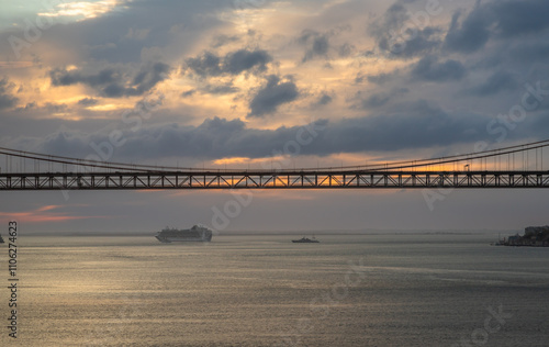 Panoramic Exposure done from a Cruise ship, while arriving at Lisbon at sunrise, of the 25th April Bridge and Tagus River, with Lisbon on the left bank and the Sanctuary of Christ the King, Lisbon,Por