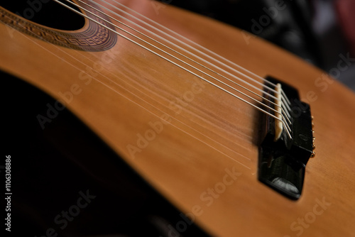 Wallpaper Mural A close-up of an acoustic guitar body focusing on the strings, soundhole, and bridge. The warm wooden tone of the instrument and soft bokeh create a cozy and musical atmosphere. Torontodigital.ca