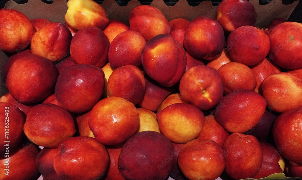 Nectarines peaches whole on supermarket. vibrant close-up of freshly harvested nectarines, showcasing their rich red and yellow hues. Nectarines peaches whole on supermarket. vibrant close-up of freshly harvested nectarines, showcasing their rich red and yellow hues.