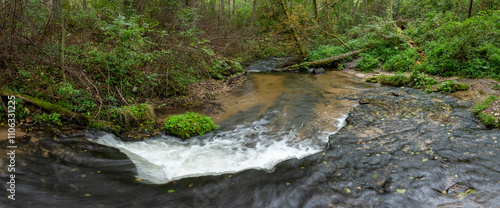 Rocky threshold on the wild, small river Sopot. Panoramic view of small water cascade, autumn. Landscape park Solska forest at Roztocze, Poland, Europe. photo