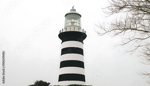 Discover the charm of lighthouse architecture with black and white stripes merging with the ocean.