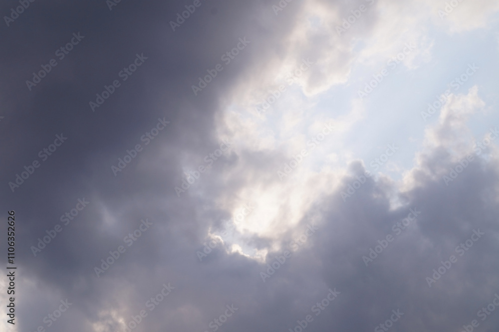 a dramatic sky filled with varying shades of gray clouds, illuminated by patches of light breaking through, creating a moody and contemplative atmosphere a dramatic sky filled with varying shades of gray clouds, illuminated by patches of light breaking through, creating a moody and contemplative atmosphere