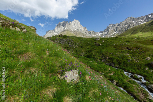 Hiking trail to Chaukhi mount from the village of Juta. Beautiful waterfall under Chaukhi. Chaukhistskhali river. Breathtaking landscape.