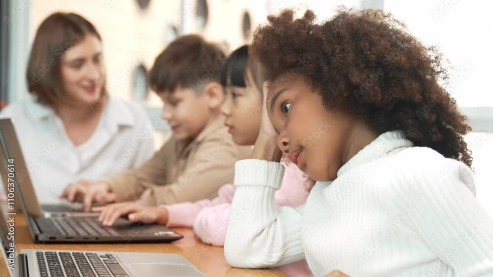 African girl play laptop with diverse friend learning prompt at STEM technology class. Multicultural student study about engineering code and programing system with blurring background. Erudition. African girl play laptop with diverse friend learning prompt at STEM technology class. Multicultural student study about engineering code and programing system with blurring background. Erudition.