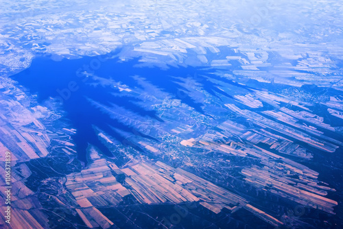 Irrigation reservoir, irrigation farming. Squares of cultivated lands and bars of settlements and roads. The Blue Earth from a birds eye view. Anthropogen. How beautiful is our Square Earth! photo