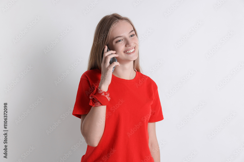 Teenage girl talking on smartphone against white background Teenage girl talking on smartphone against white background