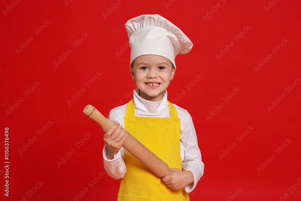 Little girl with rolling pin pretending to be chef on red background. Dreaming of future profession Little girl with rolling pin pretending to be chef on red background. Dreaming of future profession
