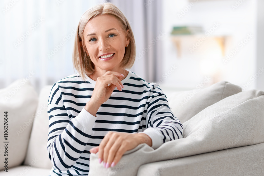 Portrait of happy middle aged woman on sofa at home Portrait of happy middle aged woman on sofa at home