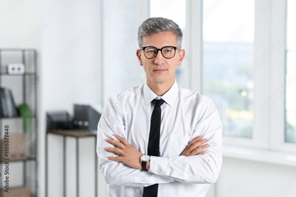 Portrait of businessman with crossed arms in office Portrait of businessman with crossed arms in office