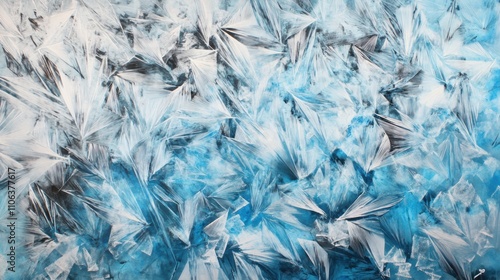 Intricate crystalline formations in icy blue and silver bloom like frosty flowers on glass, their sharp, geometric edges catching light and creating a striking, elegant pattern