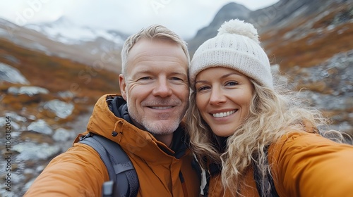 A middle-aged man with short blonde hair takes a selfie photo of himself and his wife