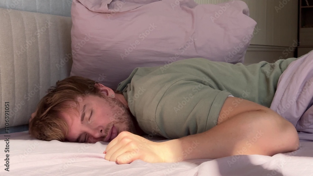 young man sleeping in bed in bedroom in the morning young man sleeping in bed in bedroom in the morning
