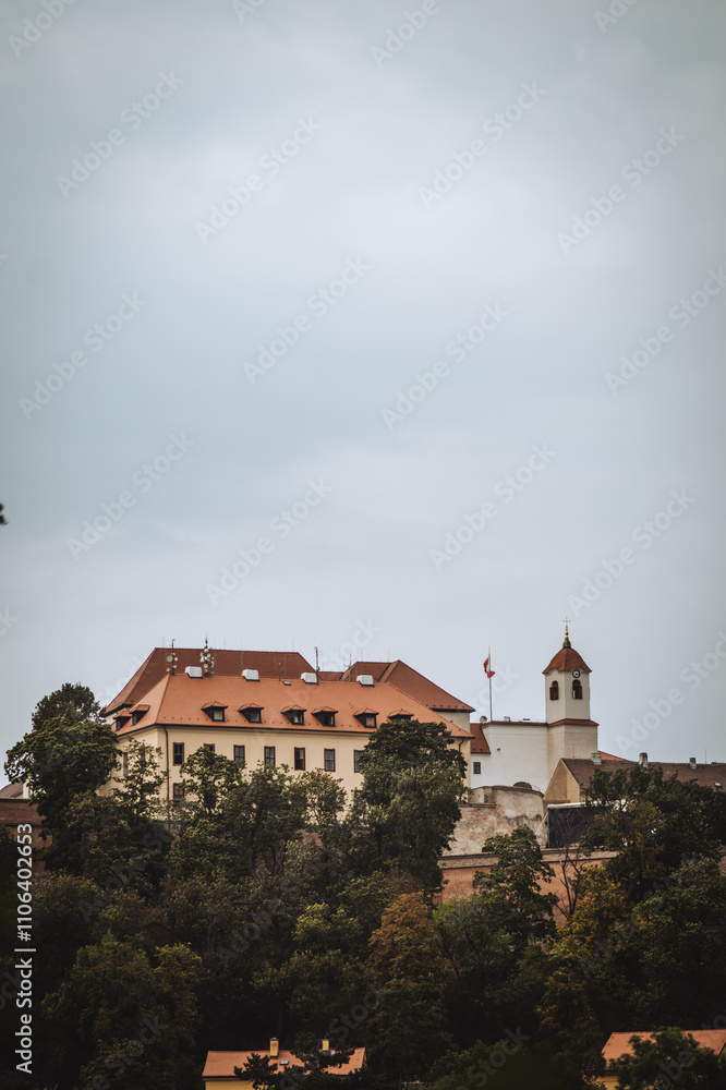 A majestic castle sits atop a hill, surrounded by lush green trees. Its red-tiled roof and white walls contrast against a cloudy sky, giving an air of historic elegance. A majestic castle sits atop a hill, surrounded by lush green trees. Its red-tiled roof and white walls contrast against a cloudy sky, giving an air of historic elegance.
