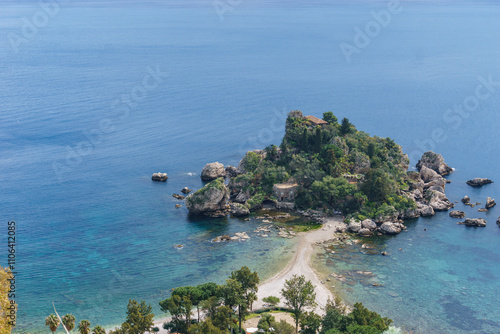 View at island Isola Bella in Taormina with clear turquoise water at the mediterranean coast on a sunny day, Sicily, Italy photo