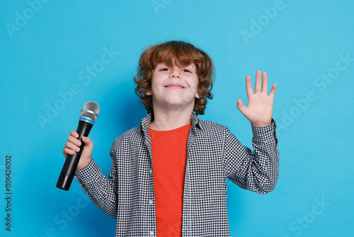 Εκτύπωση καμβά Little boy with microphone pretending to be singer on light blue background