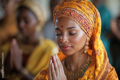 Woman praying with eyes closed in traditional dress photo