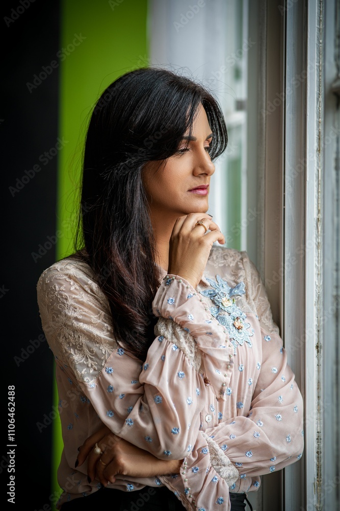 Thoughtful woman gazing out a window Thoughtful woman gazing out a window