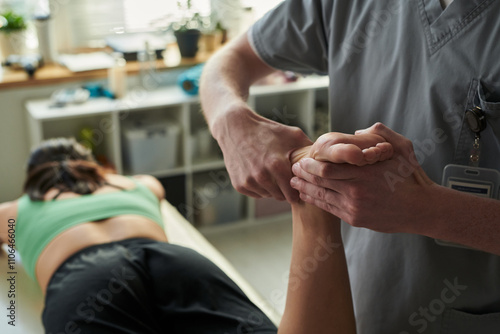 Wallpaper Mural Massage therapist working on client's arm in wellness center, maintaining professional posture and using precise technique for muscle relaxation and relief Torontodigital.ca