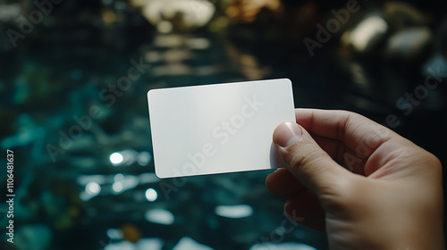 A hand holds a blank white card with rounded corners, a plain call-card template, showcasing plastic credit namecards, ideal for checking offset designs and business branding photo