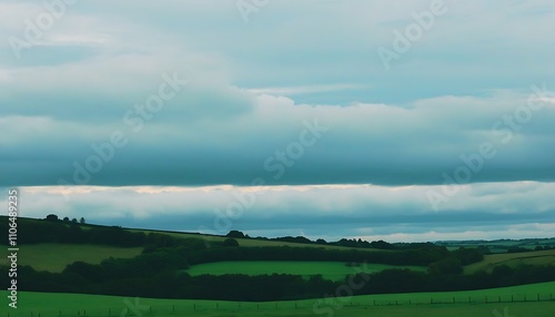 Tranquil green field under cloudy sky