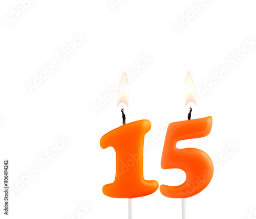 Orange birthday candle on white background - Number 15 photo