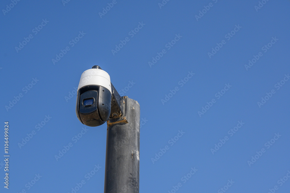 Fototapeta premium Security camera on pole in city center