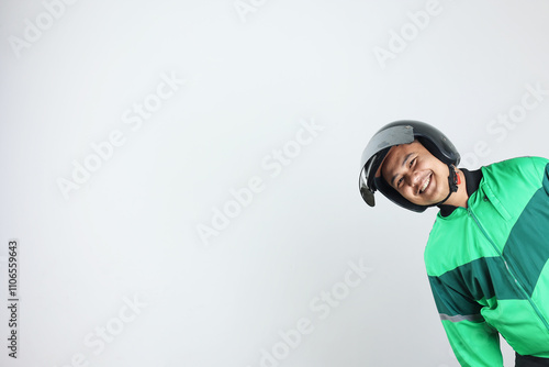 Online Taxi Driver Gojek Motorbike Man Smiling from The Side of White Wall Background photo