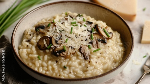 A bowl of creamy risotto infused with wild mushrooms and Parmesan cheese, garnished with fresh chives, Risotto bowl centered