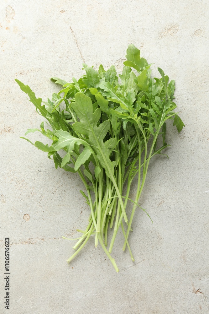 Many fresh arugula leaves on grey textured table, top view Many fresh arugula leaves on grey textured table, top view