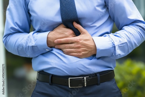 a man holding his stomach with both hands