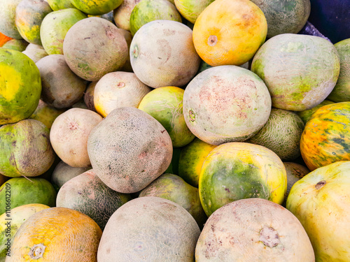 Pile of ripe and sweet green melons, fruit seller melons background.